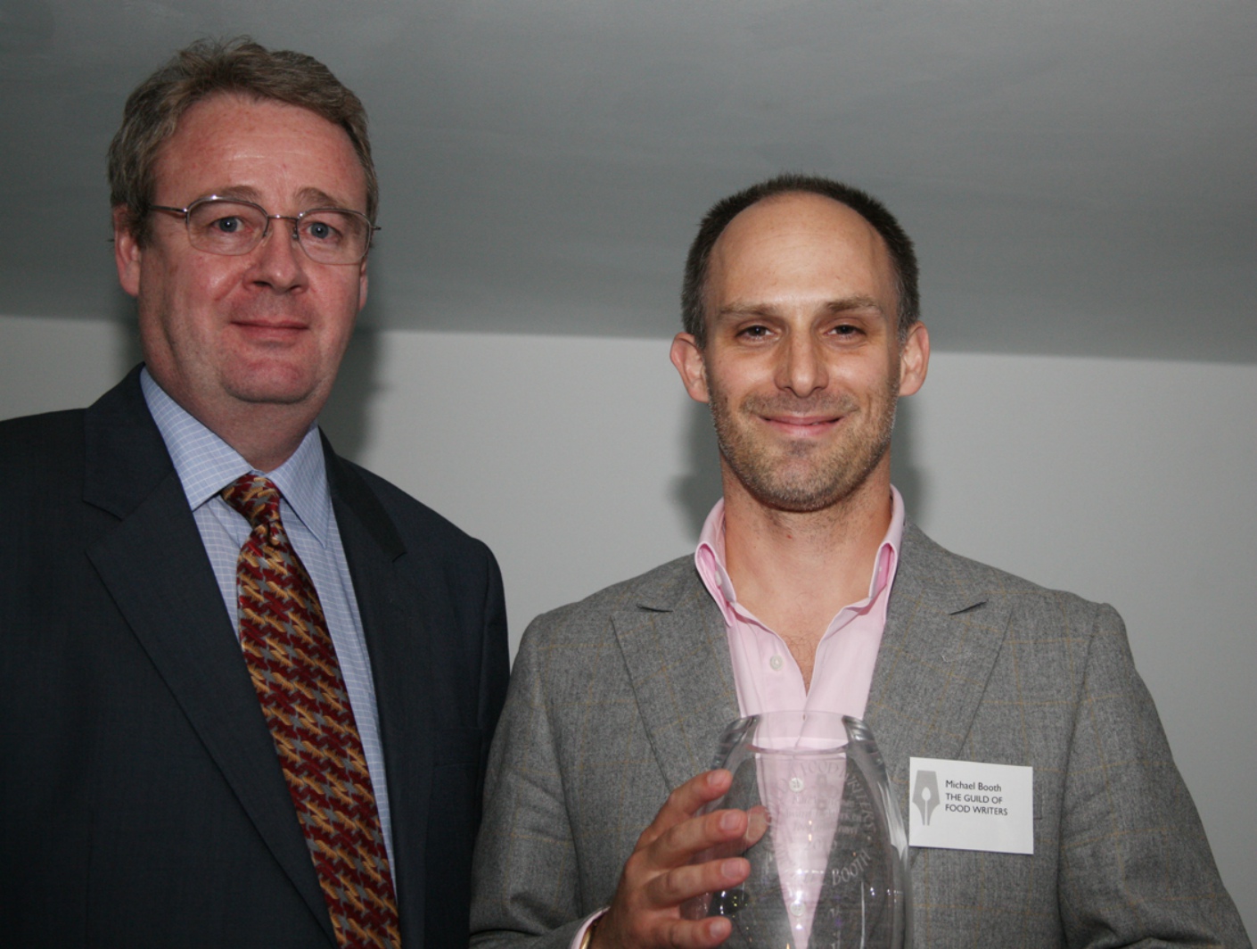 Michael Booth (right) receiving his award from Andrew Brown representing the evening's sponsors, the Alaska Seafood Marketing Institute